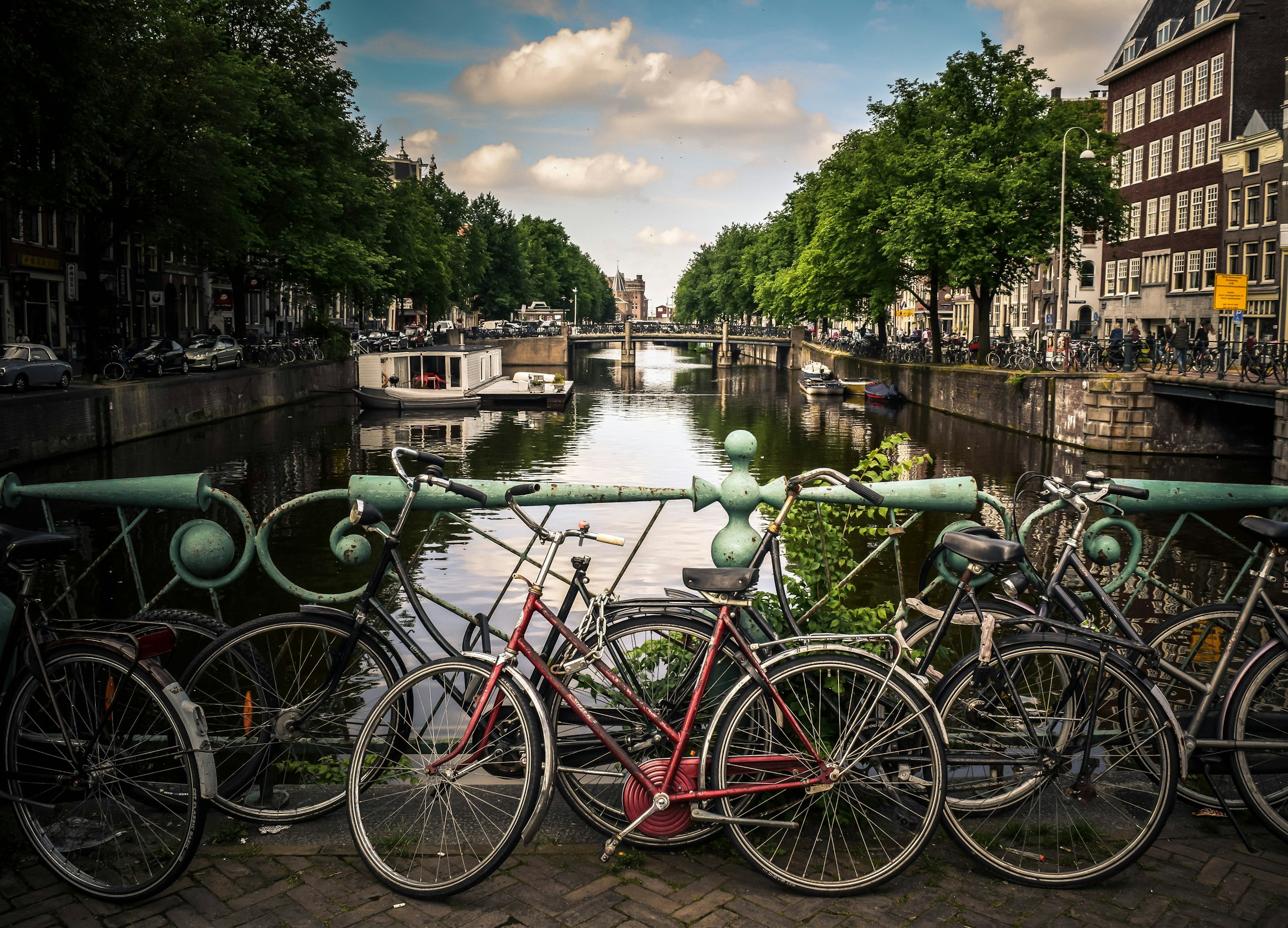 Canal houses in Amsterdam reflected in the water at golden hour