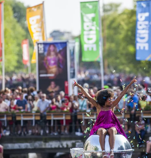 Canal houses in Amsterdam reflected in the water at golden hour
